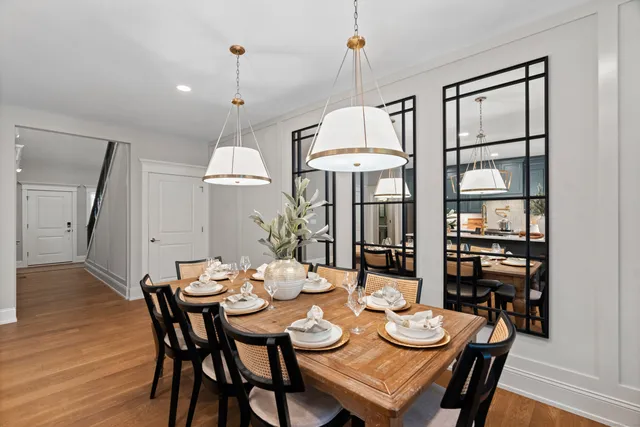 a dining room with furniture a chandelier and wooden floor