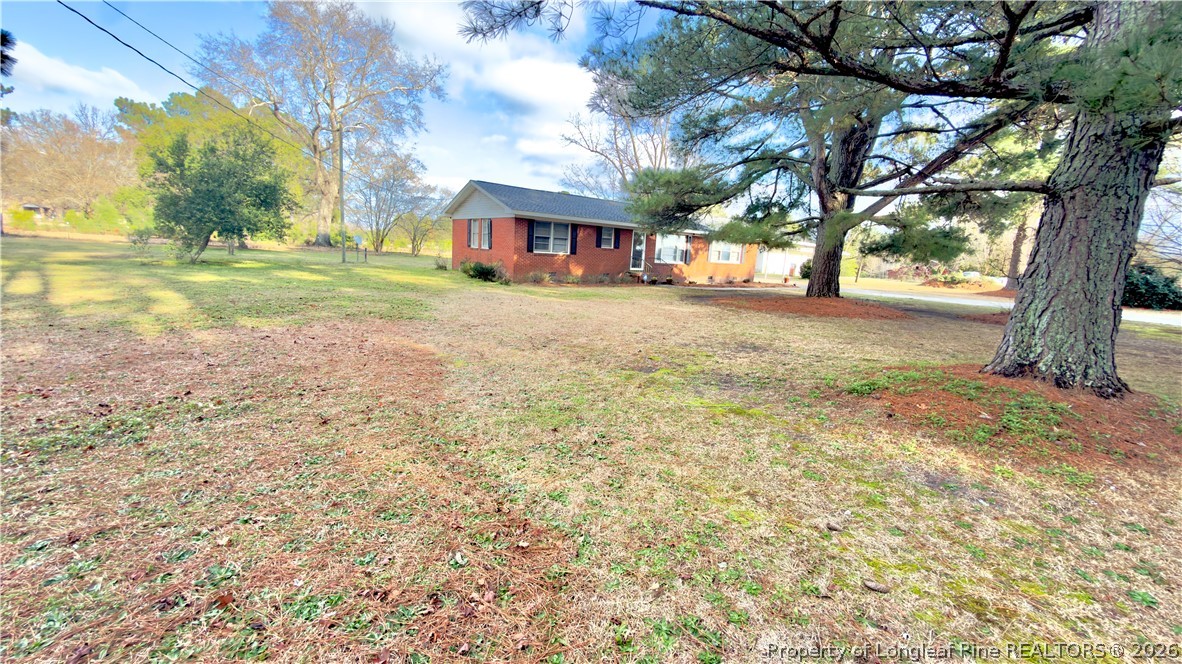 5309 Tobacco Road Orrum, NC 28369 - Photo 7 of 44 a view of a yard with plants and trees