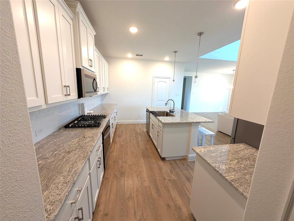 716 Blakelys Way Fate, TX 75189 - Photo 5 of 15 a living room with a couch and a table