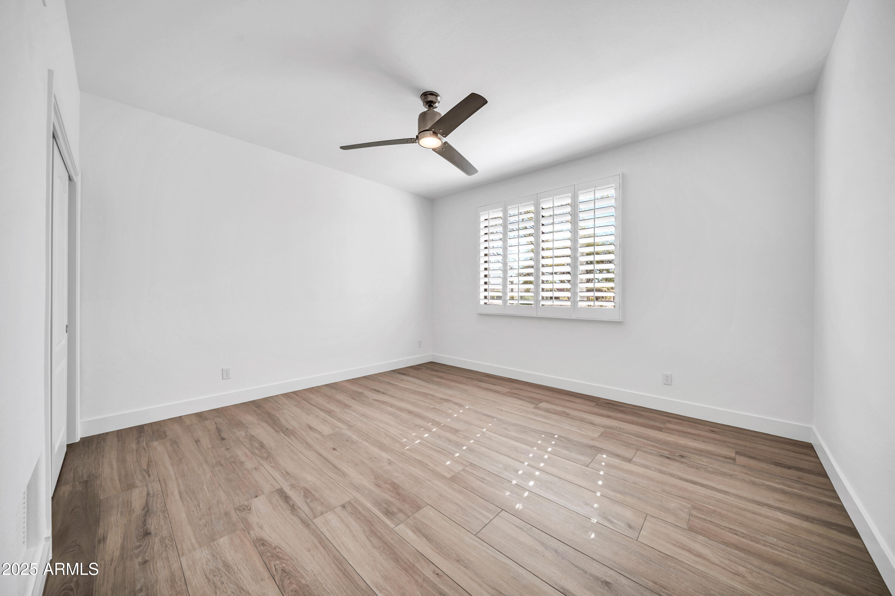 18820 East Gemmill Drive Rio Verde, AZ 85263 - Photo 46 of 72 an empty room with wooden floor ceiling fan and windows