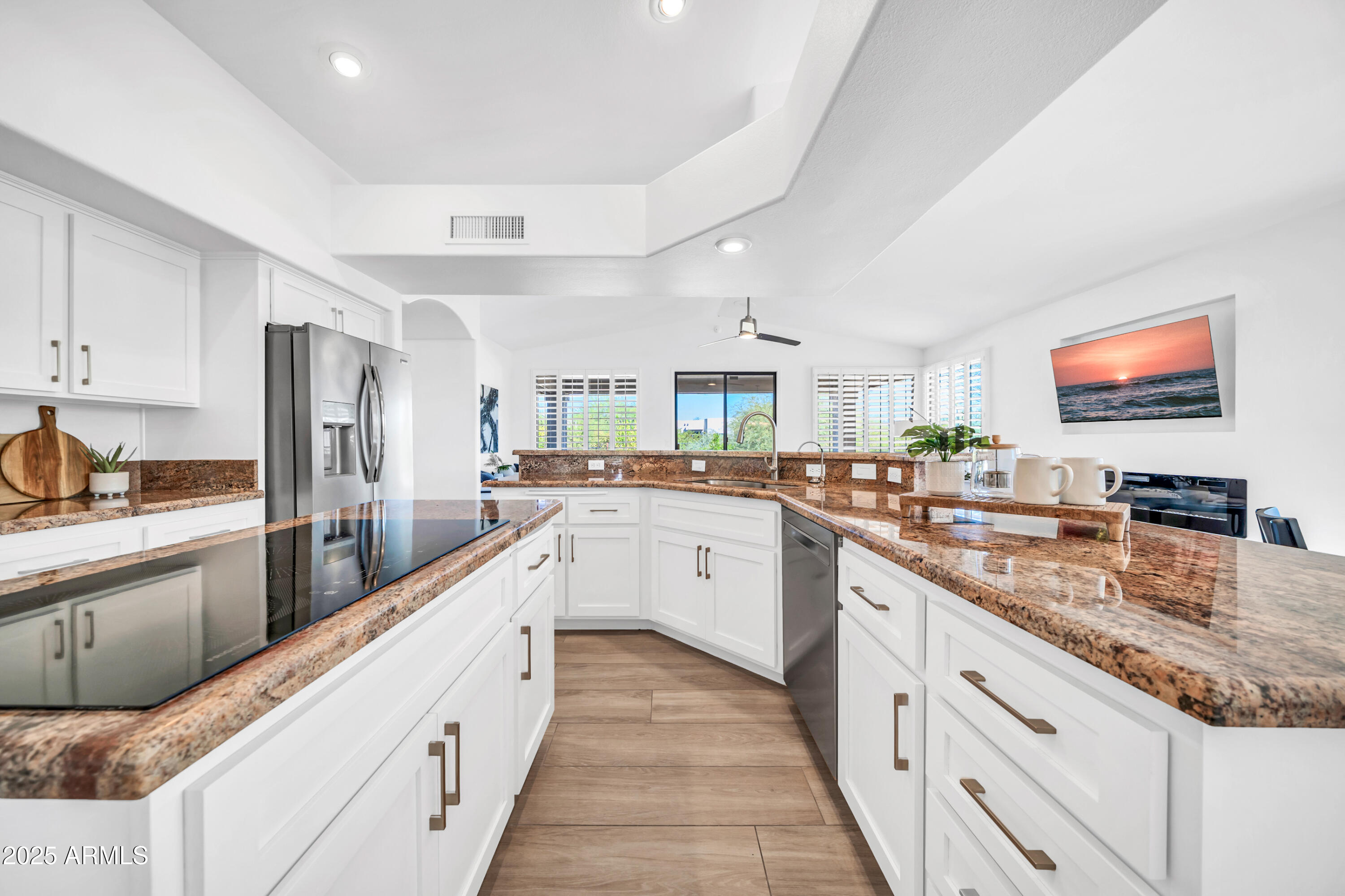 18820 East Gemmill Drive Rio Verde, AZ 85263 - Photo 7 of 72 a large white kitchen with stainless steel appliances granite countertop a lot of counter space and wooden floors