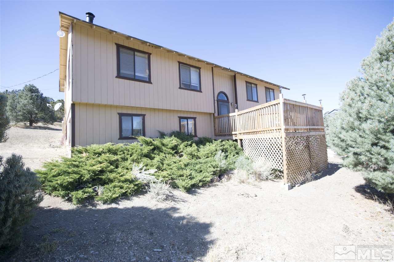 21880 Clemens Road Reno, NV 89521 - Photo 1 of 1 a front view of a house with a yard and potted plants