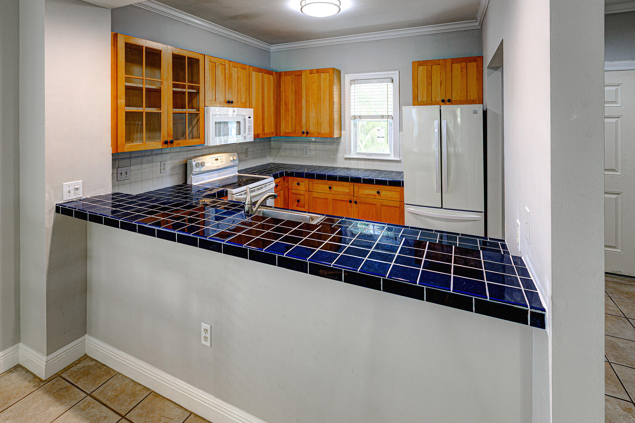 263 Golf Club Drive Key West, FL 33040 - Photo 6 of 30 a kitchen with a sink a window and cabinets