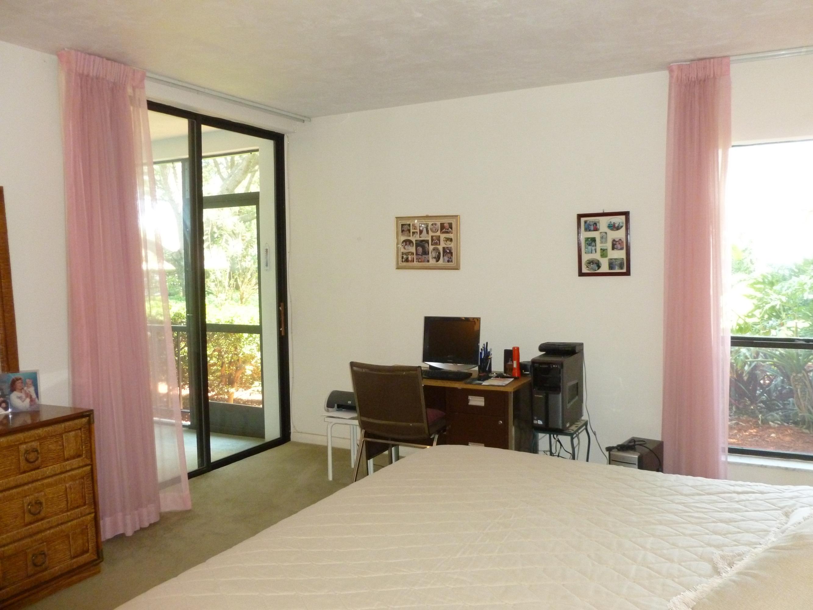 6 Concourse Drive, Unit 6B Jupiter, FL 33469 - Photo 10 of 28 MASTER BEDROOM WITH ACCESS TO PATIO