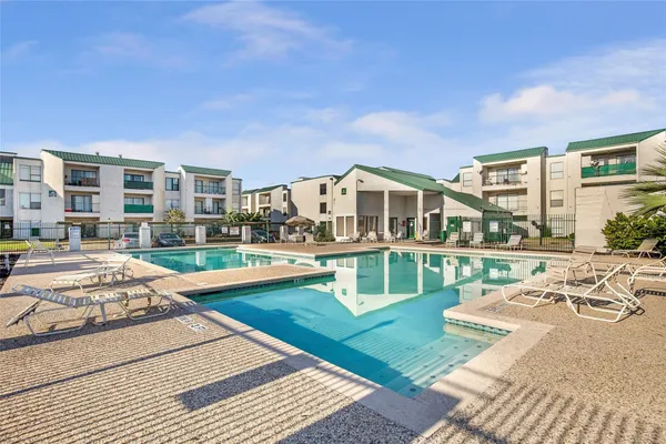 a view of a house with swimming pool and sitting area