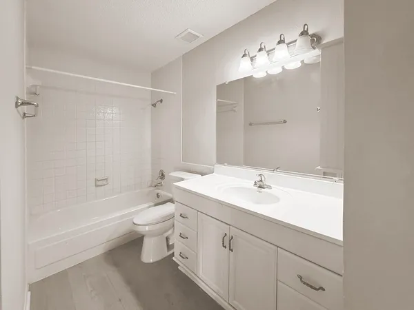 a bathroom with a double vanity sink mirror and toilet