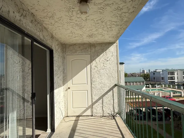 a view of balcony with furniture