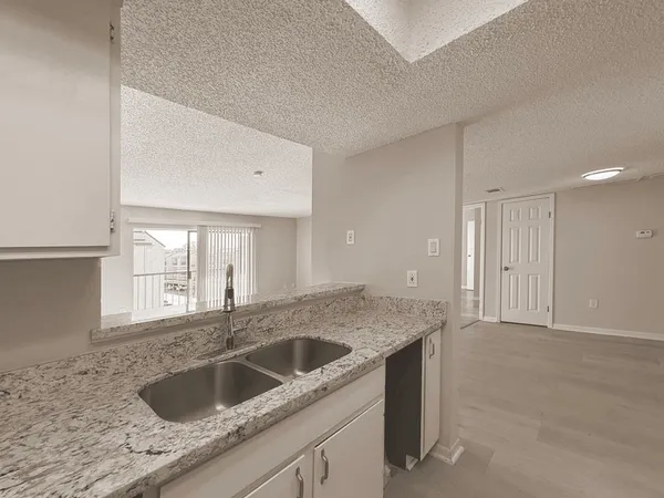 a kitchen with a sink and cabinets