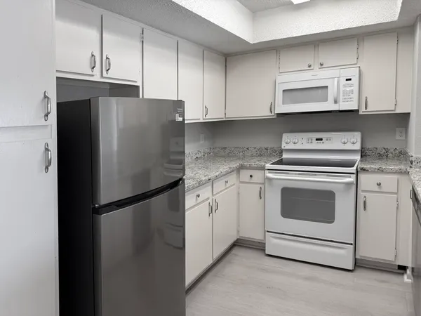 a kitchen with cabinets and stainless steel appliances