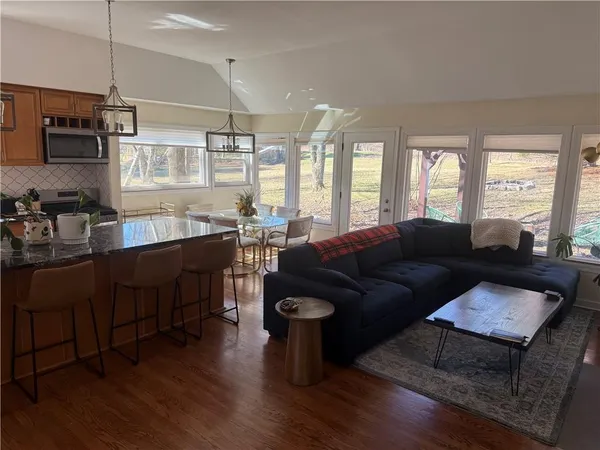 a living room with furniture flat screen tv and window