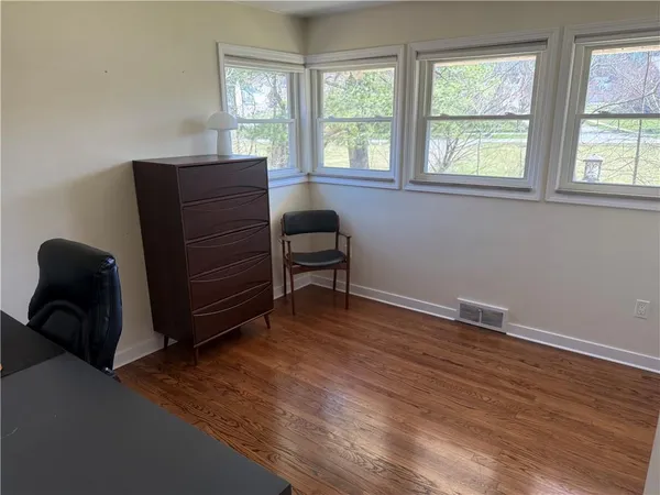 a room with a chair and a window
