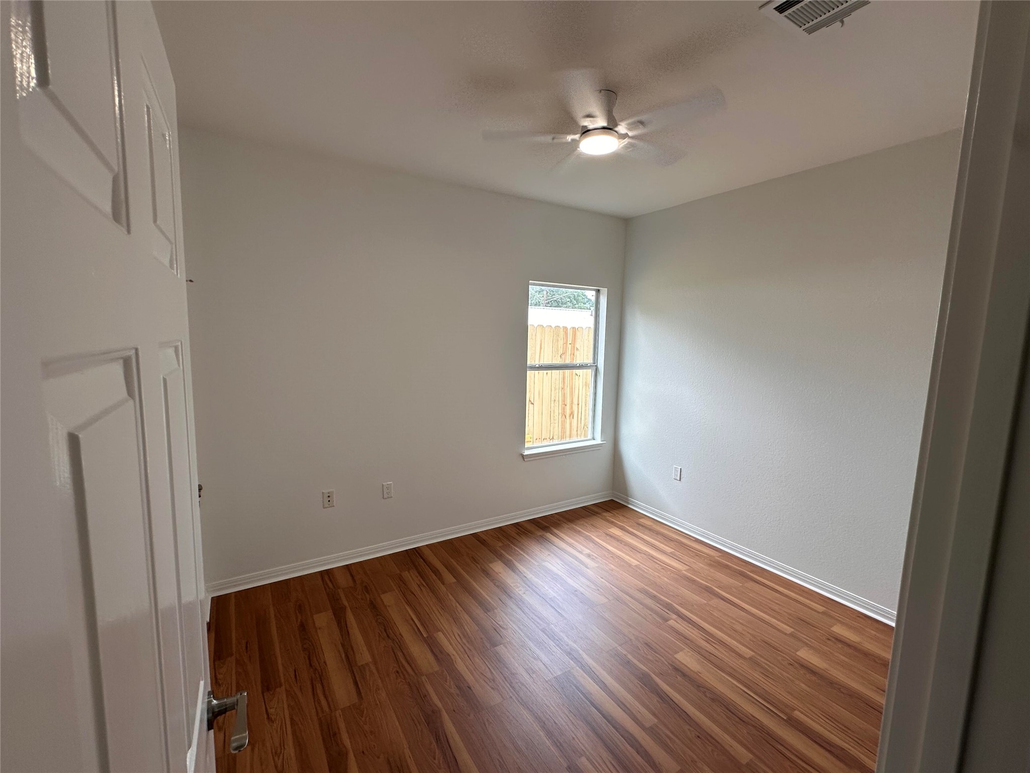 1122 Mansell Avenue Austin, TX 78721 - Photo 24 of 29 a view of an empty room with wooden floor and a window