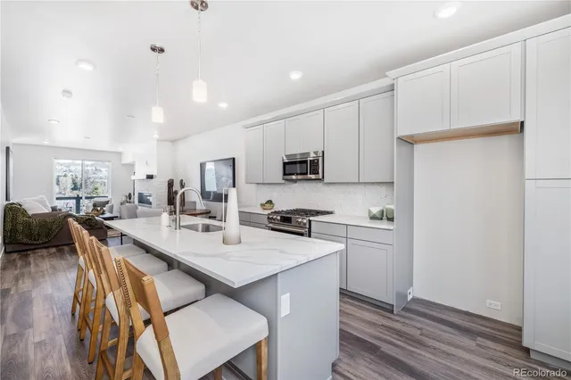 a kitchen with a table chairs refrigerator and cabinets