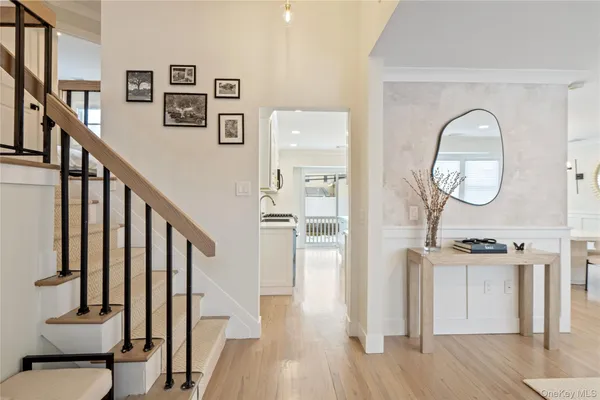 a view of a hallway with wooden floor and entryway