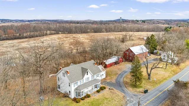 an aerial view of a house with swimming pool and mountain view