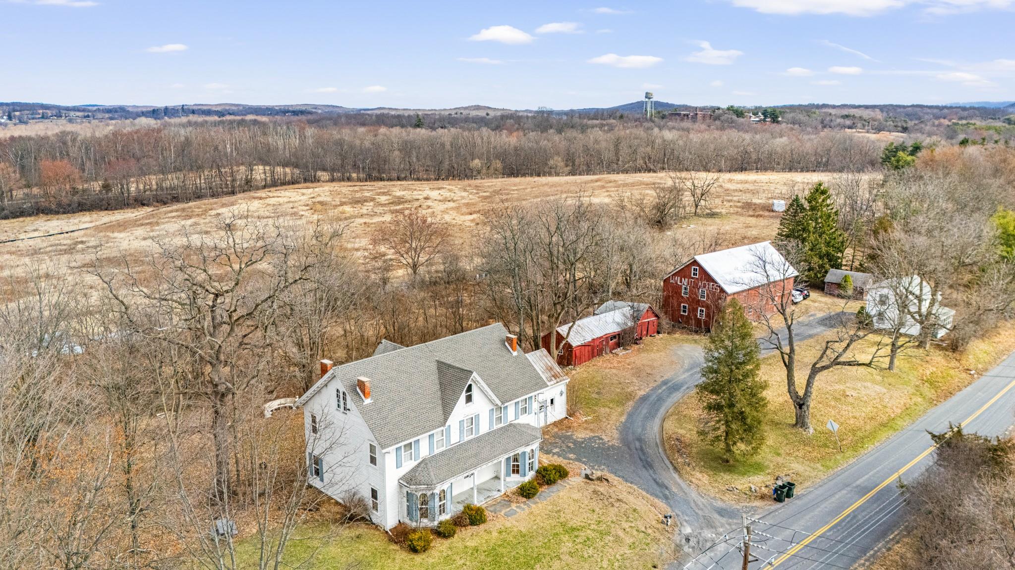 an aerial view of a house with swimming pool and mountain view