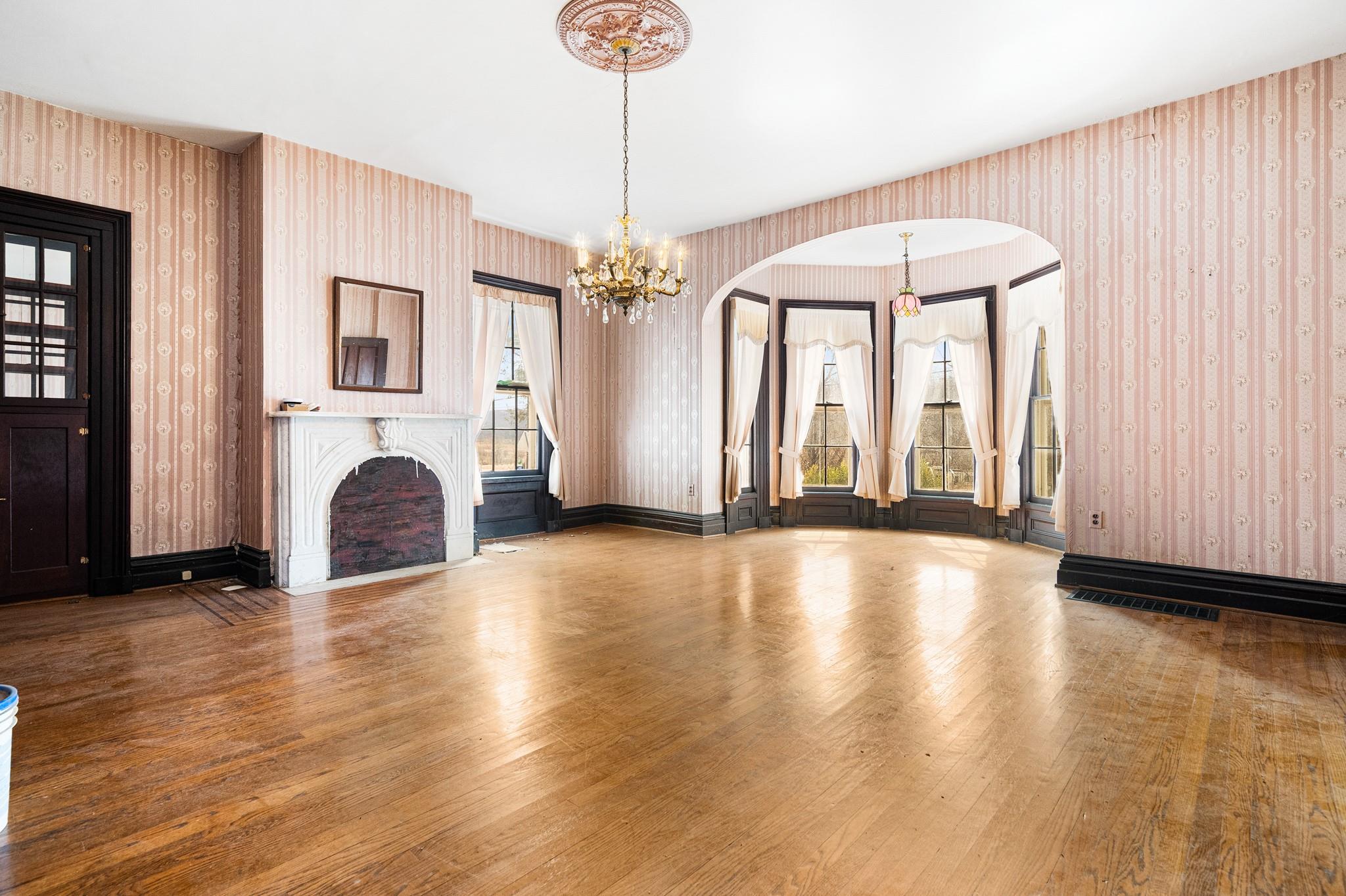 206 Greycourt Road, Unit 190 Chester, NY 10918 - Photo 32 of 49 a view of an empty room with wooden floor and a window