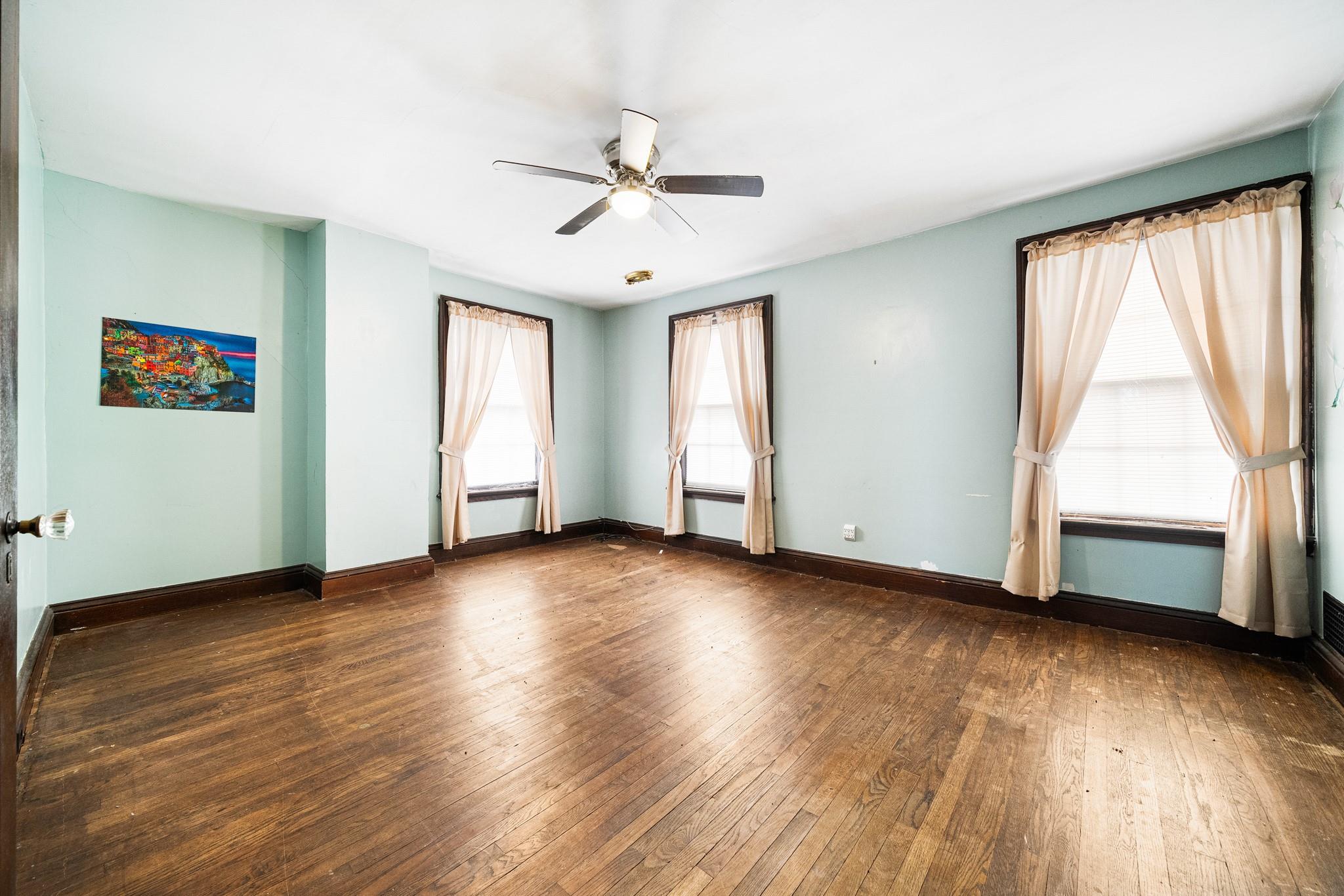 206 Greycourt Road, Unit 190 Chester, NY 10918 - Photo 42 of 49 an empty room with wooden floor chandelier fan and windows
