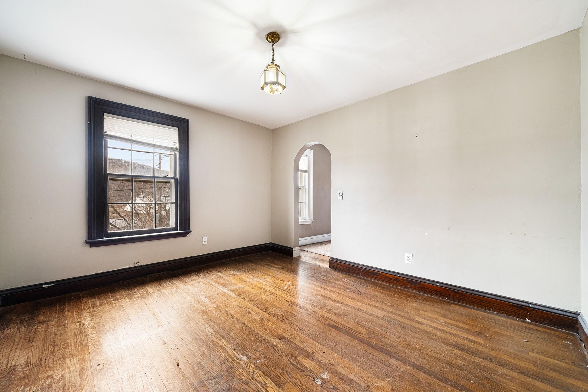 206 Greycourt Road, Unit 190 Chester, NY 10918 - Photo 44 of 49 a view of an empty room with wooden floor and a window