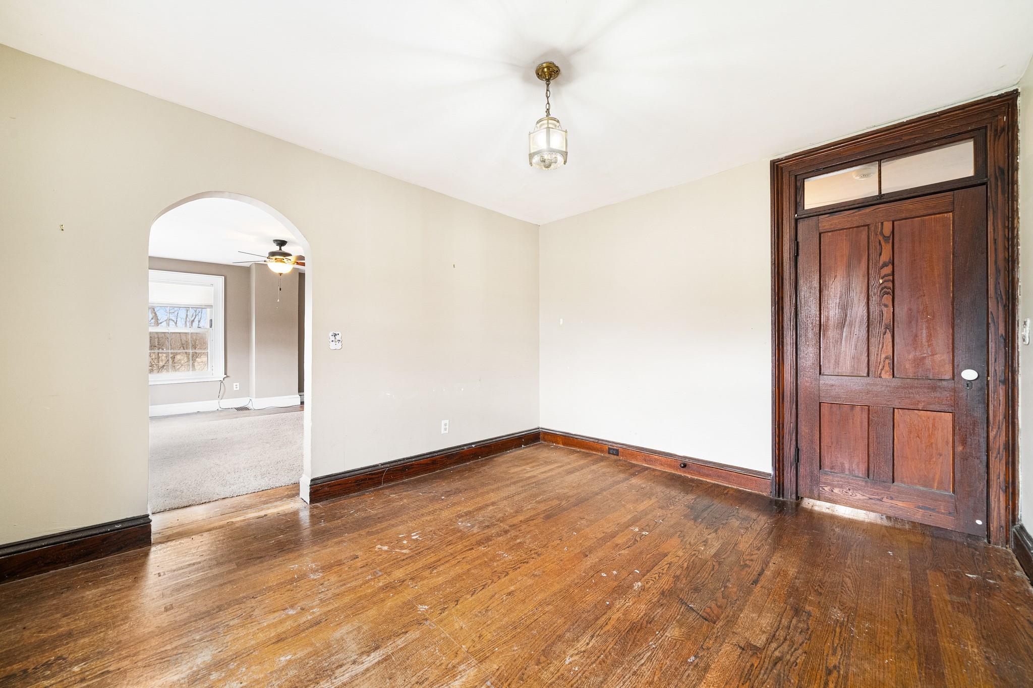 206 Greycourt Road, Unit 190 Chester, NY 10918 - Photo 45 of 49 an empty room with wooden floor cabinet and windows