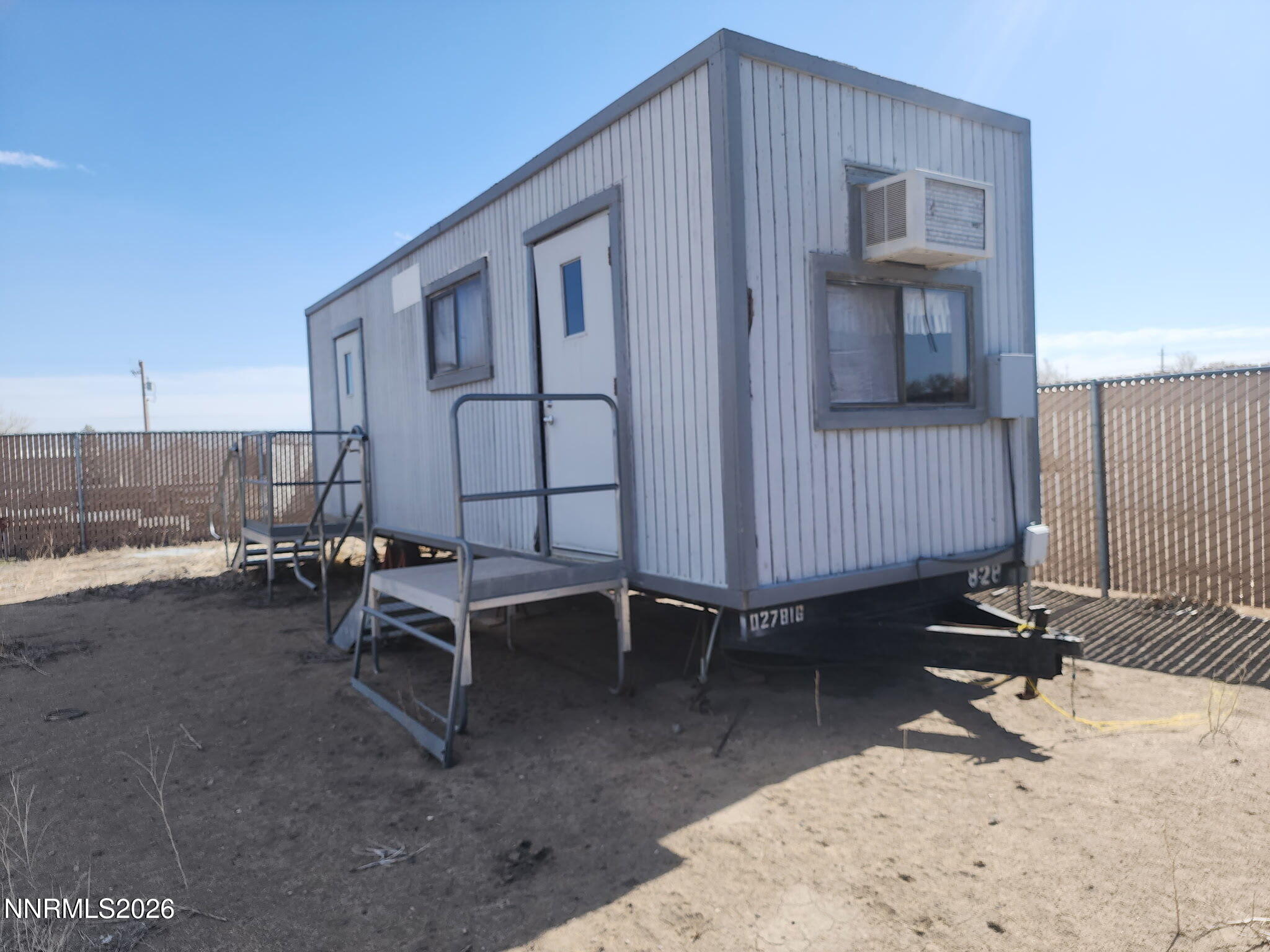 601 Windmill Drive Fallon, NV 89406 - Photo 9 of 18 a view of a backyard with chairs and iron fence