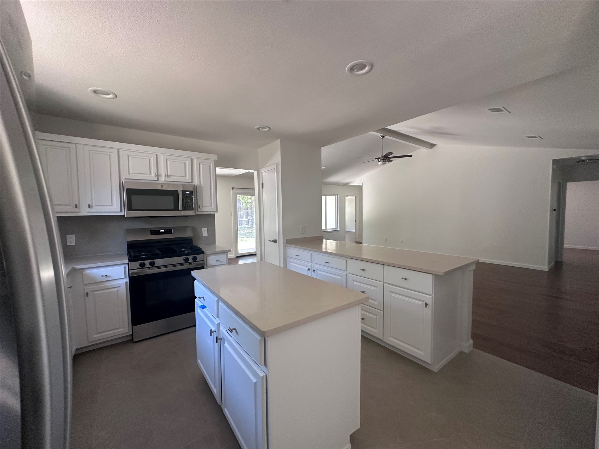 12610 Andromeda Cove Austin, TX 78727 - Photo 29 of 29 An open floor plan connects the stone-countertop kitchen to adjoining living spaces.