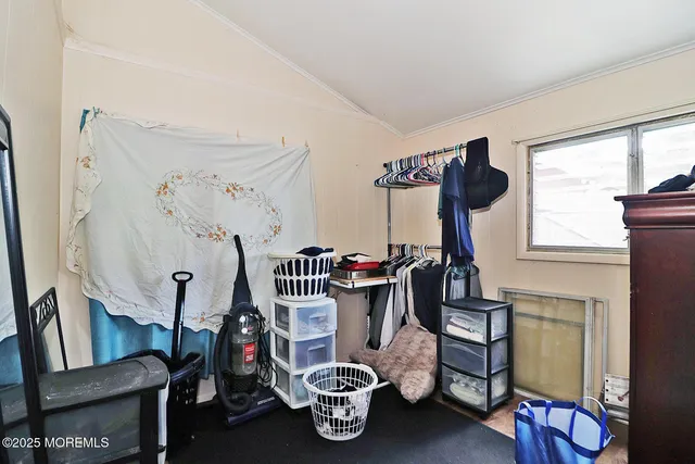 a bedroom with furniture and a window