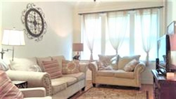 153 Strathmore Road, Unit 8 Boston, MA 02135 - Photo 2 of 14 a living room with furniture and a large window
