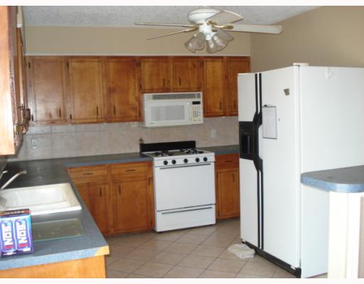 812 Lawrence Street Portland, TX 78374 - Photo 4 of 10 a kitchen with stainless steel appliances a refrigerator and a stove