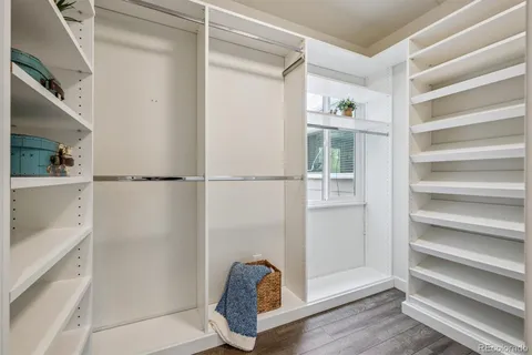 a view of walk in closet with empty racks