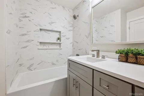 a bathroom with a sink and a bathtub with shower