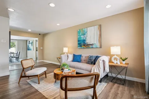 a living room with furniture and a wooden floor