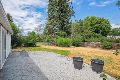 a view of a backyard with swimming pool