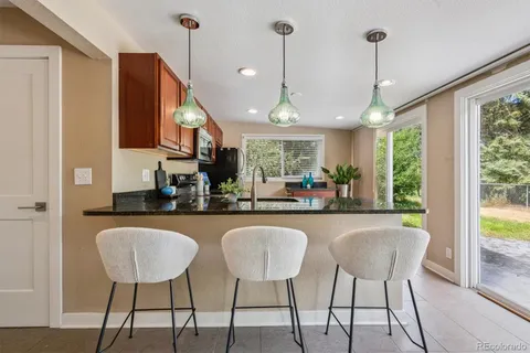 a dining table seating chairs and chandelier