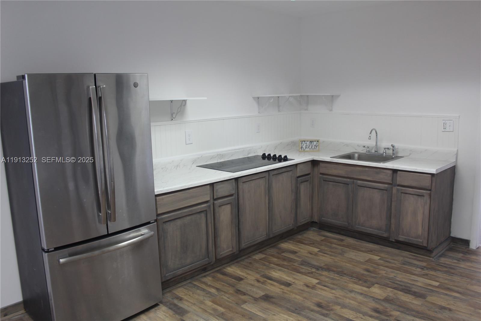 19879 Southwest 328th Street, Unit 2 Homestead, FL 33030 - Photo 2 of 20 a kitchen with stainless steel appliances granite countertop a refrigerator sink and cabinets
