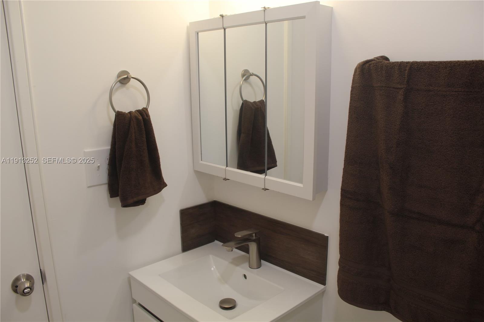 19879 Southwest 328th Street, Unit 2 Homestead, FL 33030 - Photo 3 of 20 a bathroom with a sink and a mirror