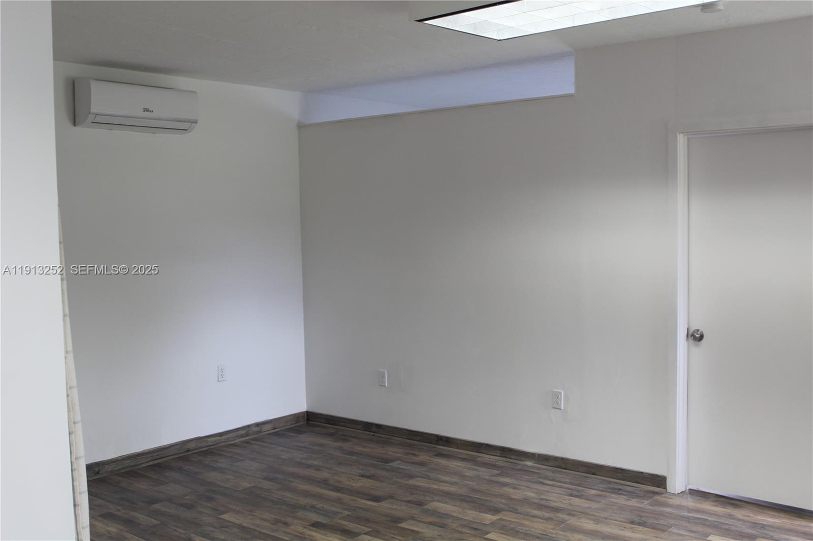 19879 Southwest 328th Street, Unit 2 Homestead, FL 33030 - Photo 6 of 20 a view of an empty room with wooden floor