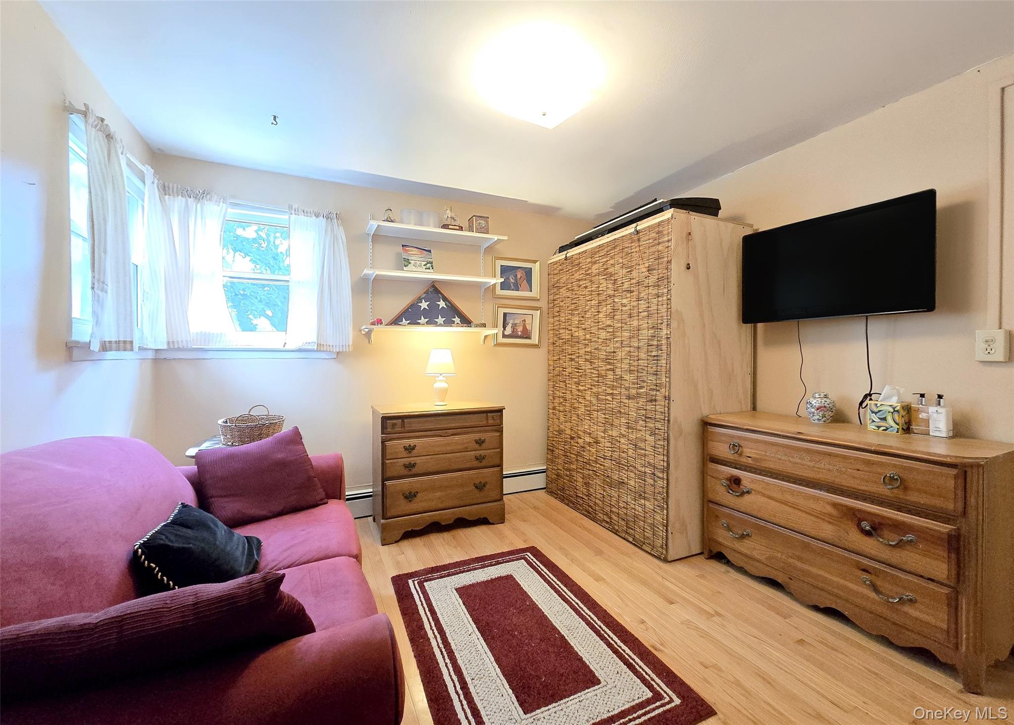 8 Corvette Road Selden, NY 11784 - Photo 14 of 21 a living room with furniture and a flat screen tv