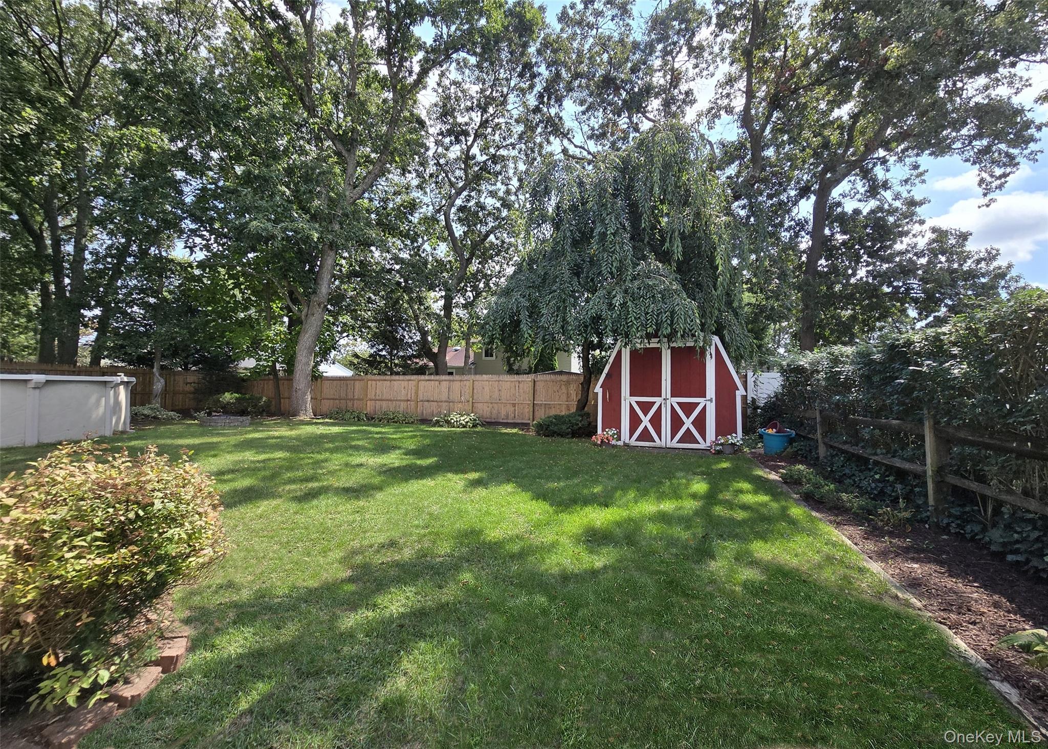 8 Corvette Road Selden, NY 11784 - Photo 21 of 21 a backyard of a house with lots of green space