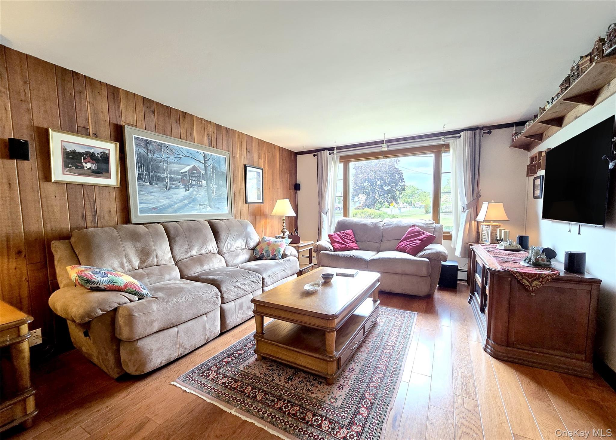 8 Corvette Road Selden, NY 11784 - Photo 4 of 21 a living room with furniture a flat screen tv and a window