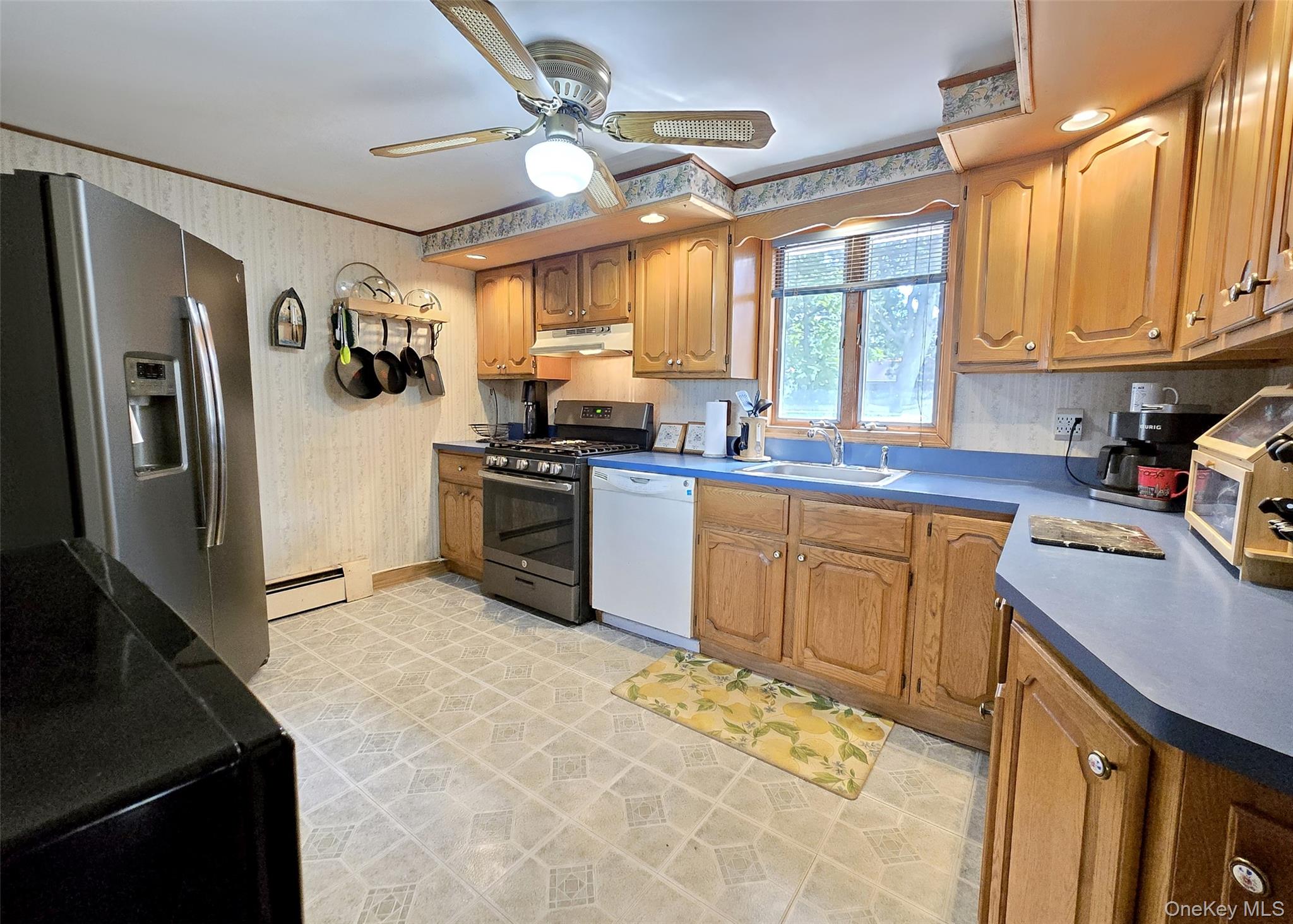 8 Corvette Road Selden, NY 11784 - Photo 7 of 21 a kitchen with stainless steel appliances granite countertop a sink stove refrigerator and cabinets