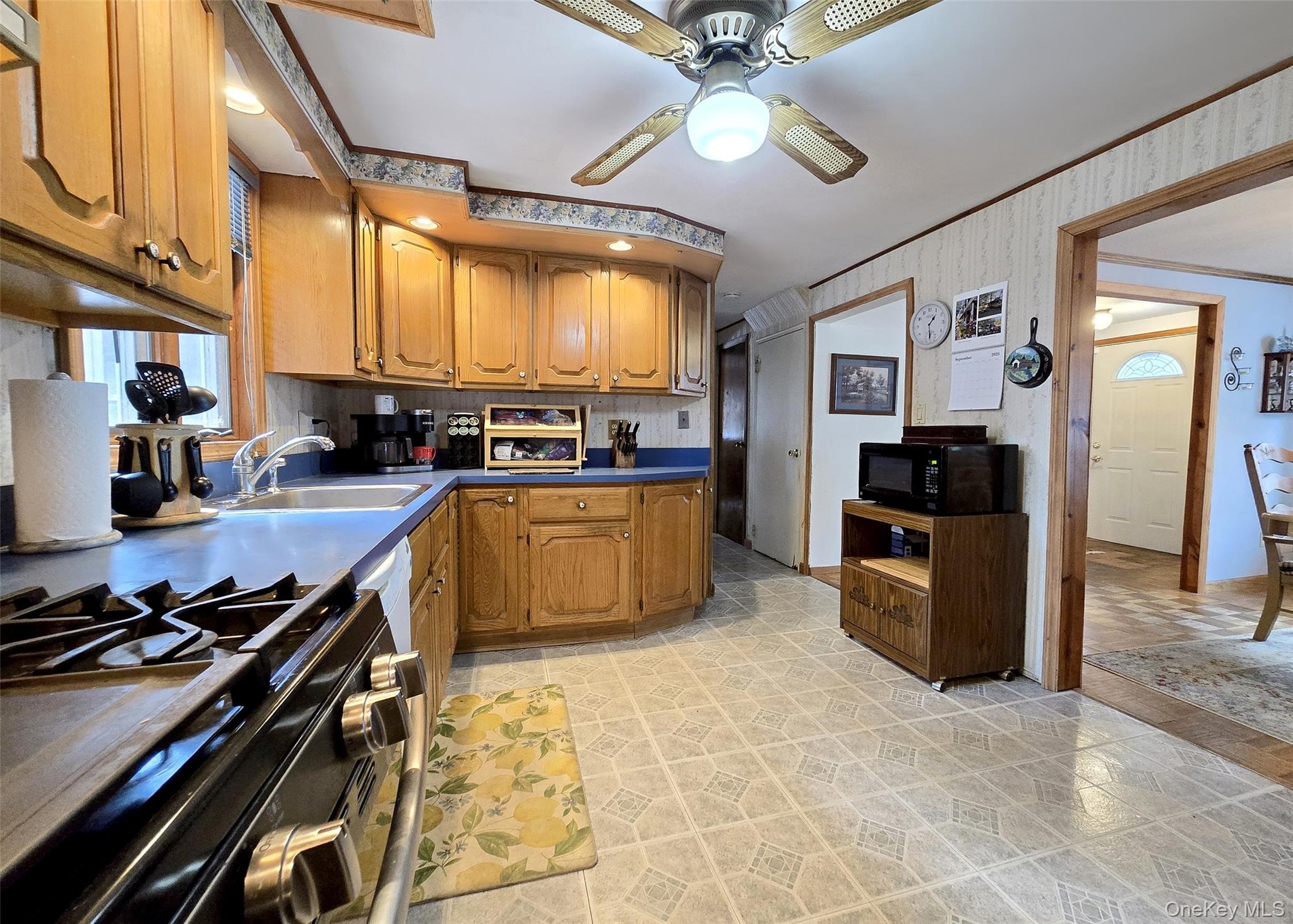 8 Corvette Road Selden, NY 11784 - Photo 8 of 21 a kitchen with stainless steel appliances a stove top oven a sink a counter top space cabinets and furniture