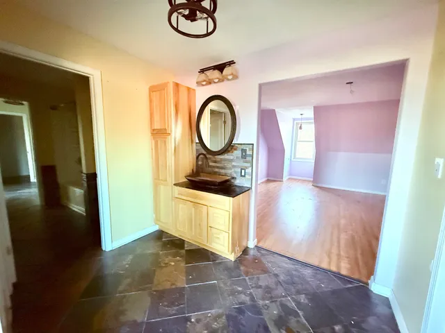 a view of empty room with wooden floor