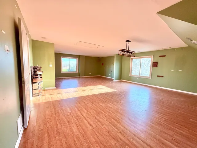 a view of staircase with wooden floor and a chandelier