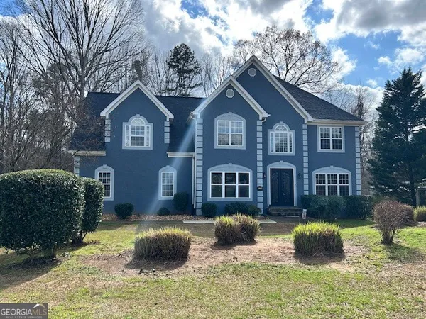 a front view of a house with a yard