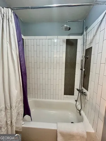 a bathroom with a shower and a tub