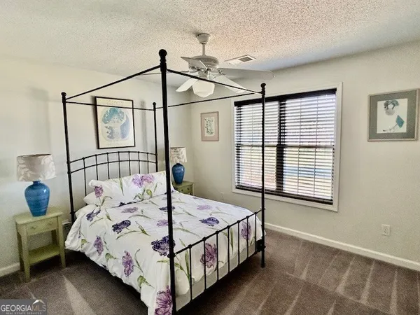 a bedroom with a bed window and a table