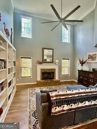 a living room with furniture fireplace and a window