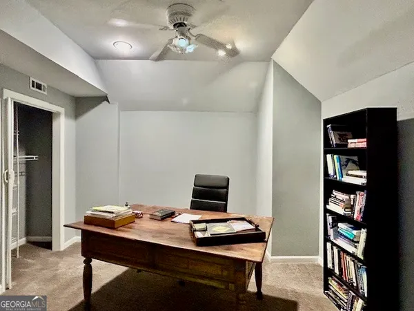 a view of a workspace with furniture