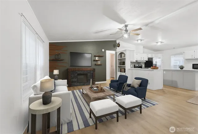 a view of a livingroom with a chandelier fan and windows